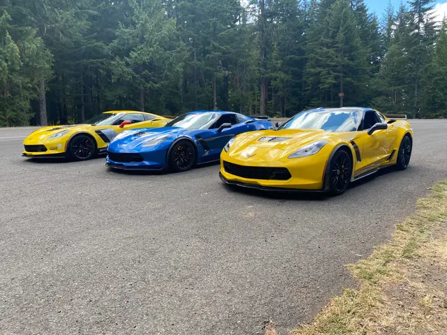 Three Chevrolet Corvette C7s lined up outdoors for track preparation