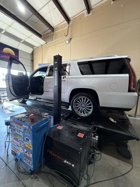 White Cadillac Escalade secured on the RPM Logic Dynojet for calibration