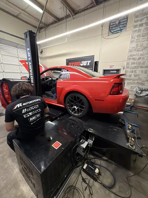 Red New Edge Ford Mustang GT strapped to the Dynojet during a tuning session